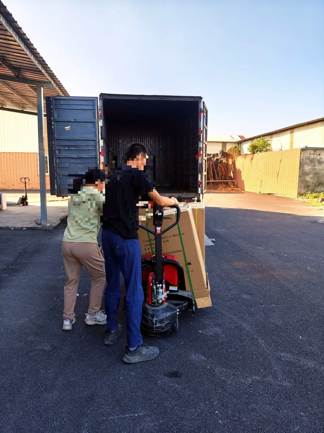 Loading crew guiding the first cartons into the truck