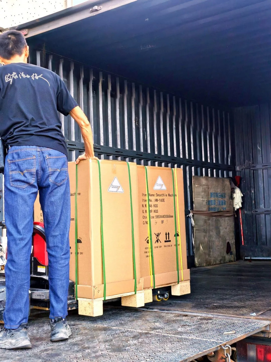 Loading team positioning a unit inside the truck body