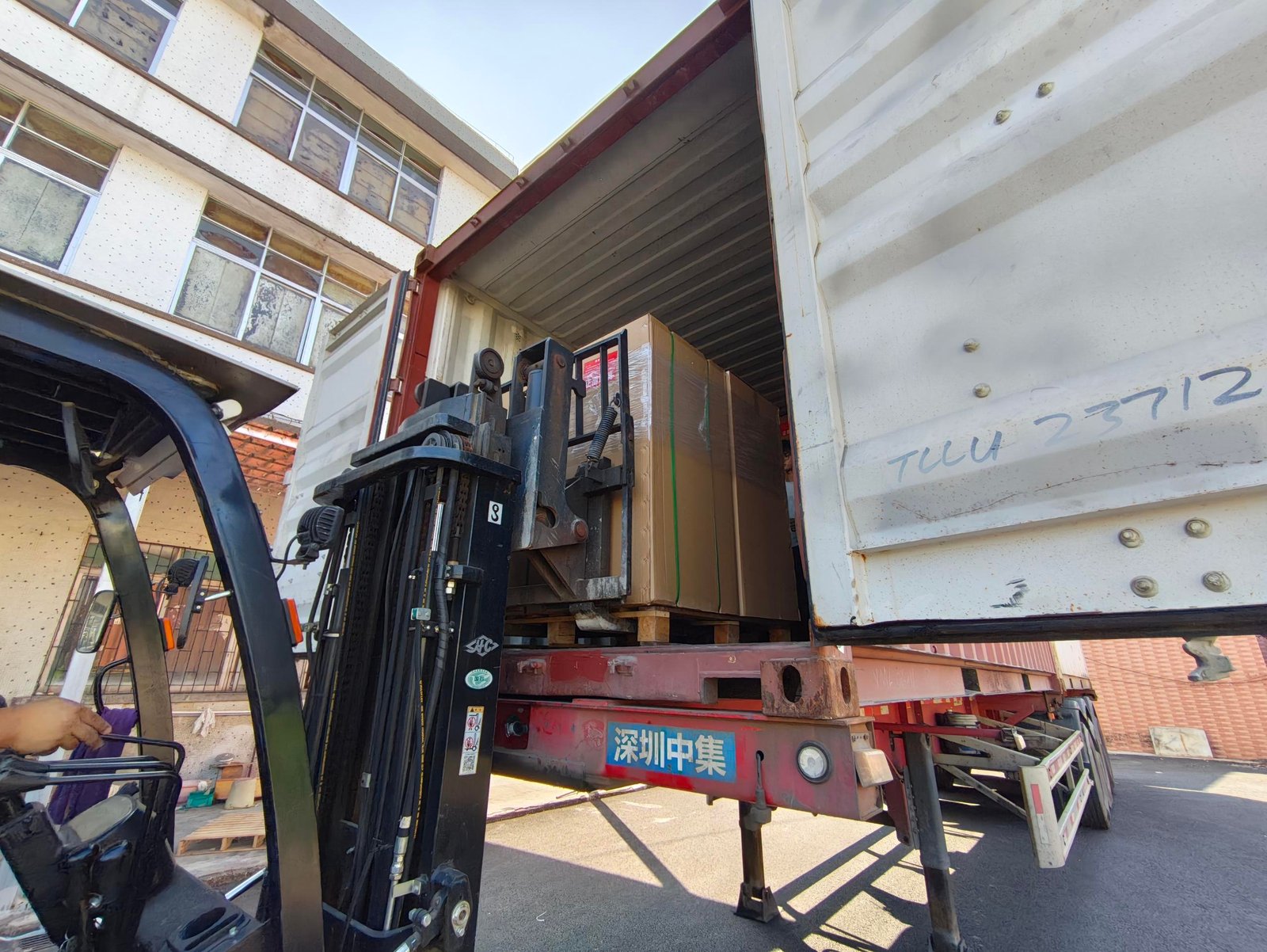Forklift entering container
