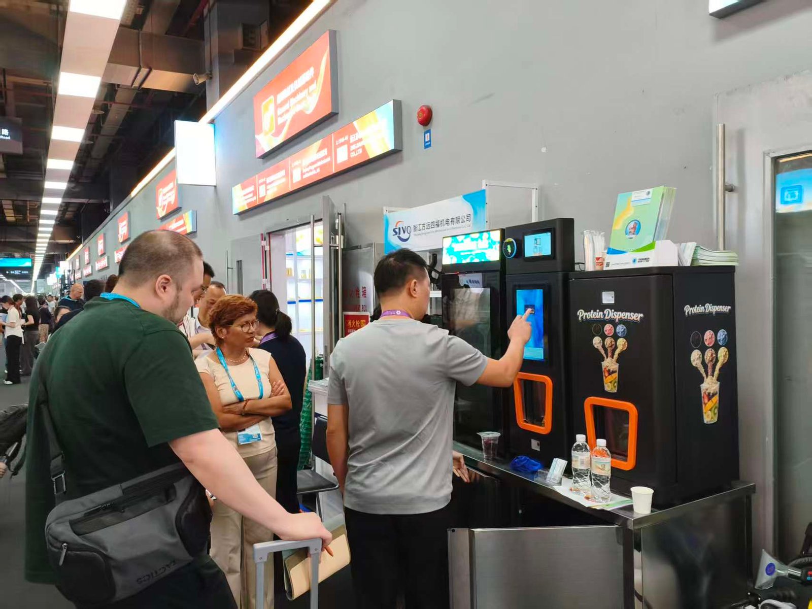 International clients interacting with the Protein Dispenser and beverage dispensing machine