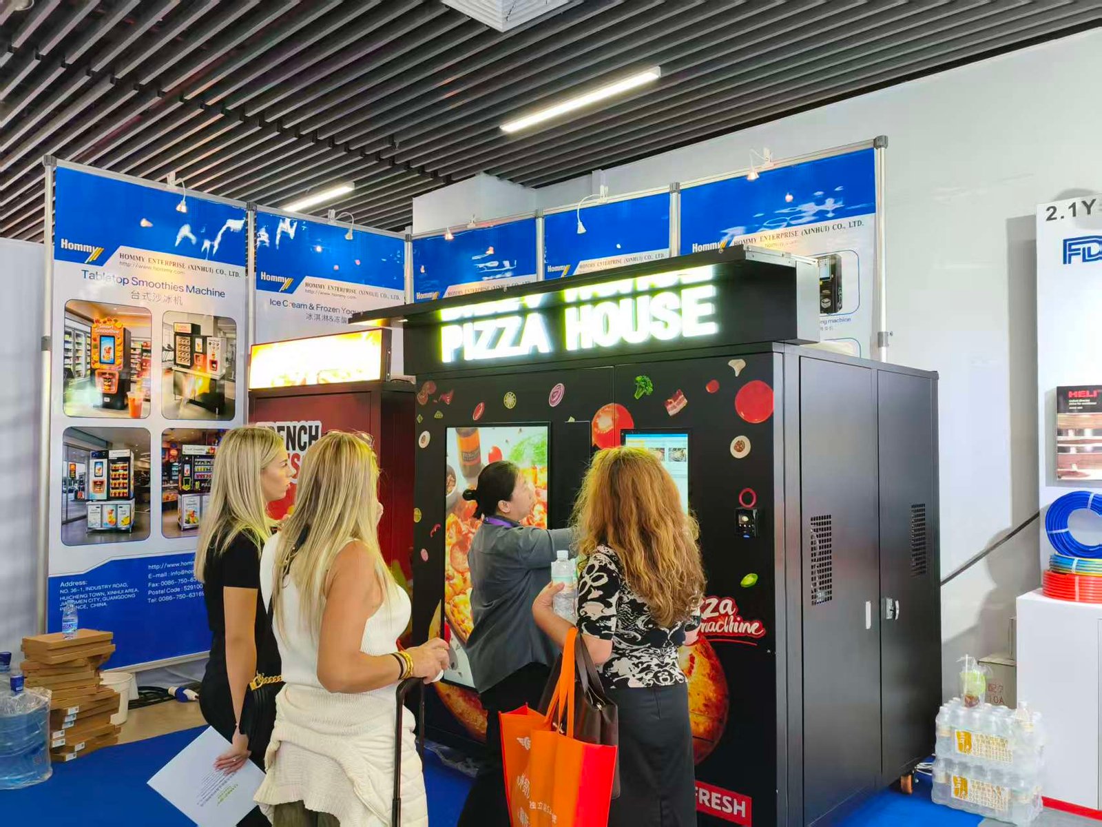 Overview of our bustling booth featuring the Pizza House smart vending machine at the Canton Fair